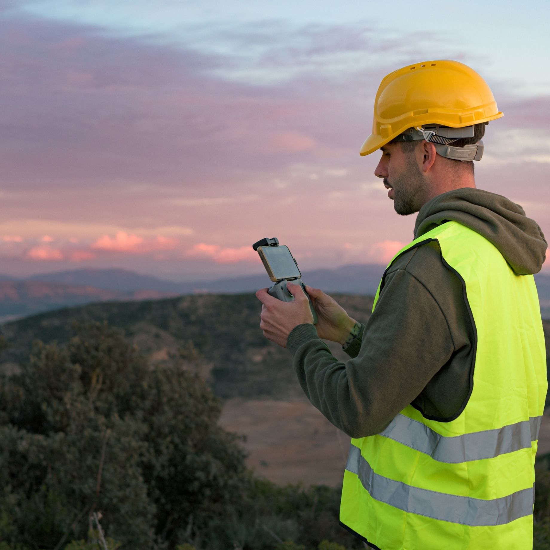 Man surveying mountains with a drone