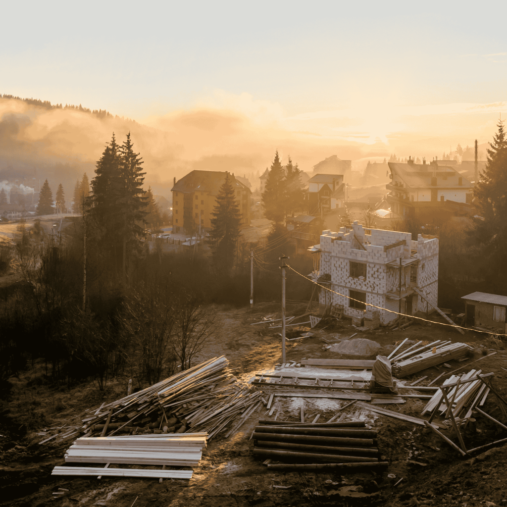 A mountain construction site with sun & fog.