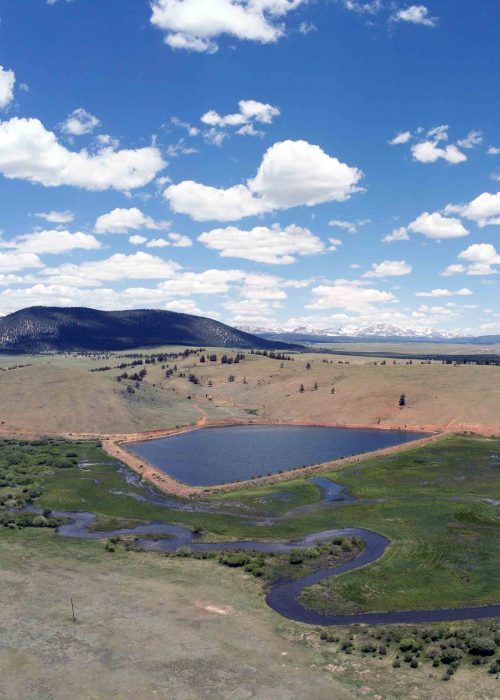 High view shot of a river and retention pond in a valley in Western Colorado